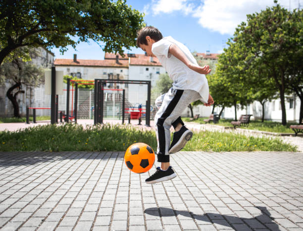 istock Boy play with football ball 959023142