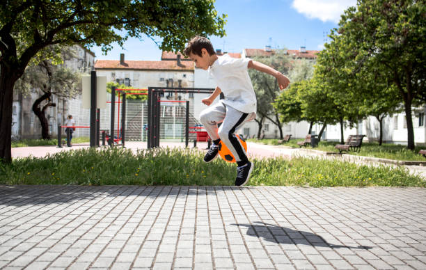 istock Boy play with football ball 959023144