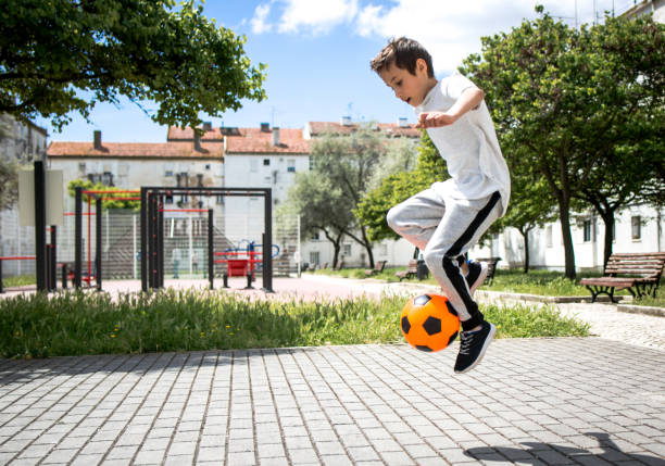 Boy play with football ball