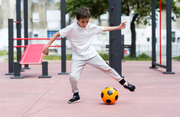 istock Boy play with football ball 959023222