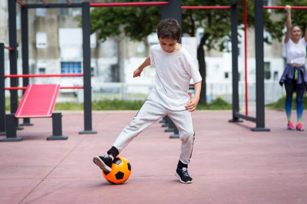 istock Boy play with football ball 959023226