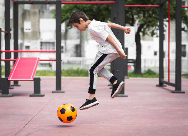 istock Boy play with football ball 959023228