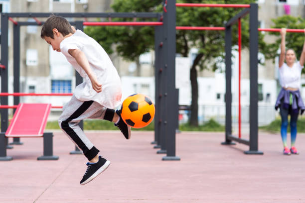 istock Boy play with football ball 959023230