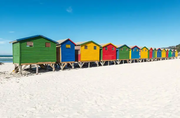 The white sand beach of Muizenberg with its colorful wooden beach huts near Cape Town, South Africa.