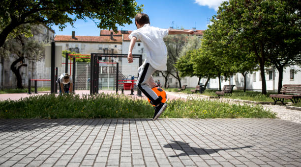 Boy play with football ball