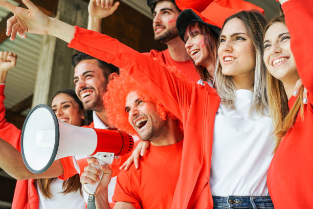 football supporter fans watching international match - young group of excited friends having fun supporting the soccer world game at stadium - youth, sport and celebration score concept - soccer celebration success group of people imagens e fotografias de stock