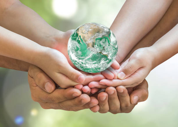 green globe in family volunteer hands for earth day and csr with people concept. elements of this image furnished by nasa. - earth globe mother child imagens e fotografias de stock