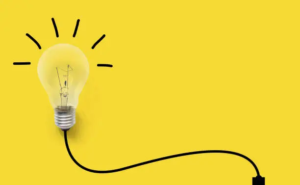 Photo of Creative thinking ideas brain innovation concept. Light bulb on yellow background