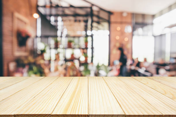 istock Wood table with Restaurant cafe or coffee shop interior with people abstract defocused blur background 959027010