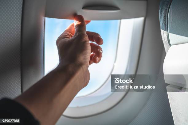 Man Adjusting The Blinds On An Airplane Window Pov Stock Photo - Download Image Now - Airplane, Window Blinds, Window