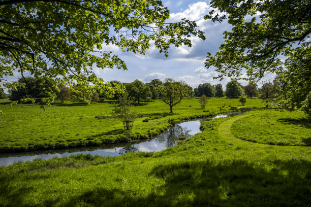 istock view over lush green river valley in spring sunlight 959028454