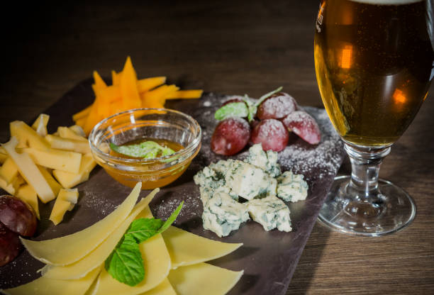 istock Cheese mix with honey and grapes on a stone background 959031544
