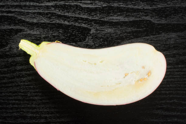 istock Fresh raw striped Eggplant on black wood 959031746