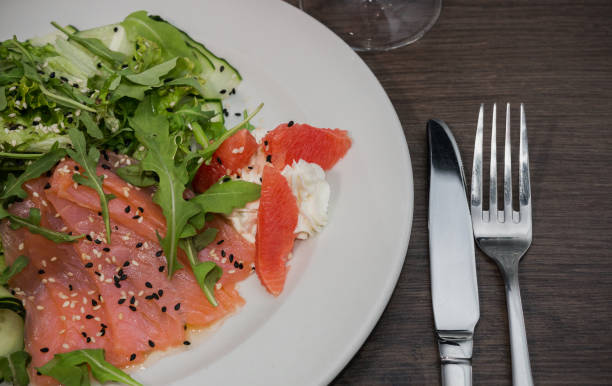 istock Meat of trout on a plate with vegetables and grapefruit 959031984