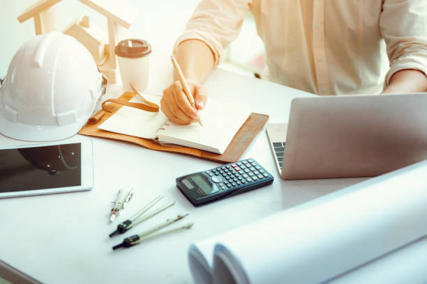 istock Close up portrait of civil engineer taking note construction planning report, Engineering and construction concept 959032274