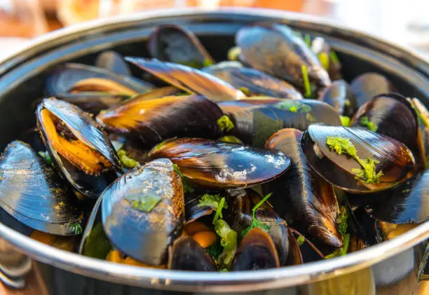 Front view of a bowl of mussels with fries. A traditional belgian summer dish. Photographed in Ostend, Belgium.