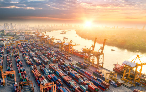 istock Logistics and transportation of Container Cargo ship and Cargo plane with working crane bridge in shipyard at sunrise, logistic import export and transport industry background 959035734