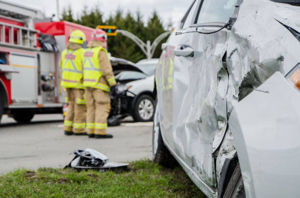 istock Close up on a car crashed with fireman in background 959038720