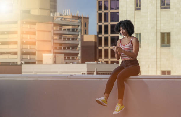 istock Woman in city texting 959039712