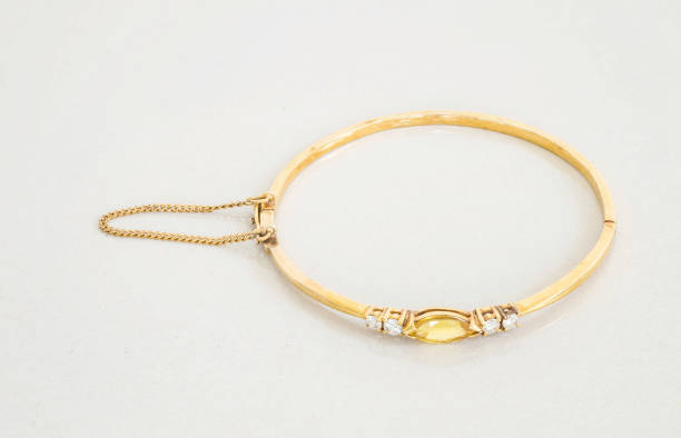 istock Closeup gold bracelet on gray marble stone background 959049120