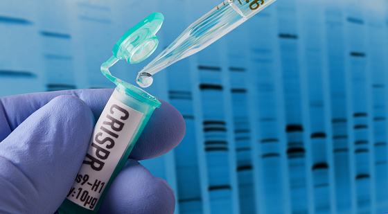 Hand holding vial doing CRISPR genomic research ++ DNA created in graphics program++