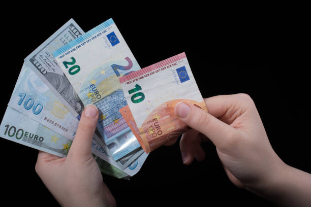 istock Hand holding American dollar  isolated on black background 959056902