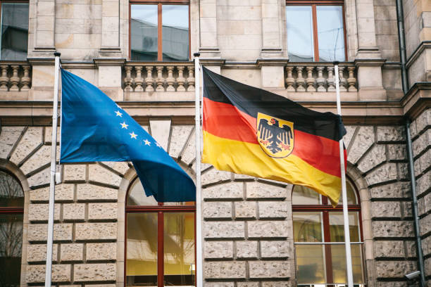 Flag of Germany and the European Union in Berlin. State symbol and national government flag of the Federal Republic of Germany and EU Flag of Germany and the European Union in Berlin. State symbol and national government flag of the Federal Republic of Germany and EU. coalition building stock pictures, royalty-free photos & images