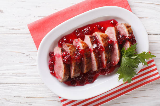 istock Festive food: roast duck breast with cranberry sauce close-up. Horizontal top view 959066836