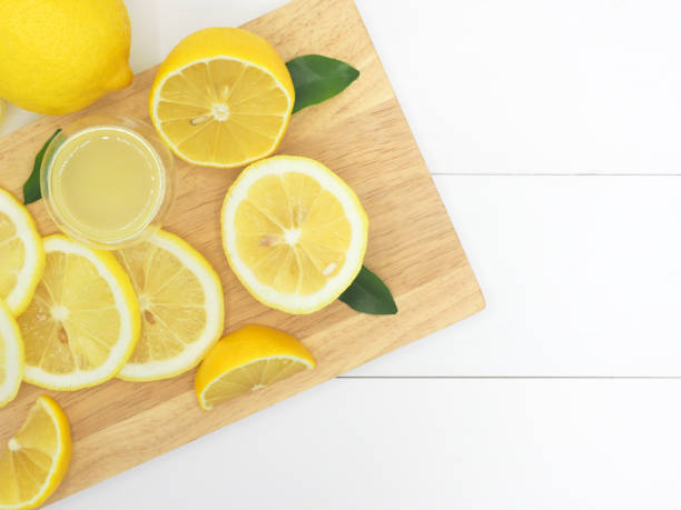 istock Fresh lemon slice with lemonade on white wood background 959067200