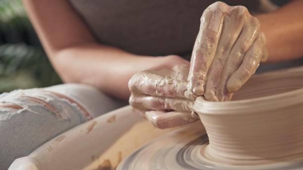 istock The process of creating pottery on a potter's wheel. Close up 959070146