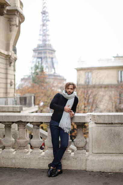 istock Afro american young man standing near concrete railing with Eiffel Tower background in Paris 959070520