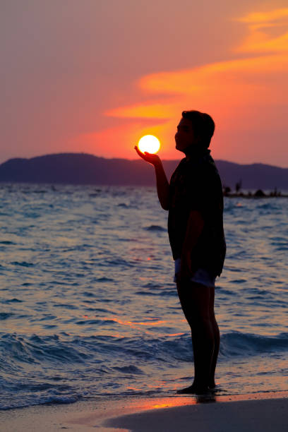 man happy with the sunset on the beach