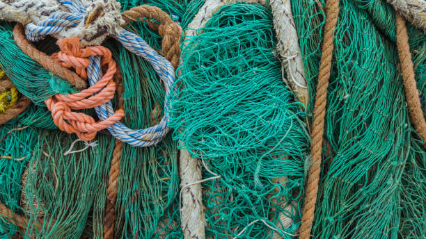 istock Old fishing green nets and ropes 959075864
