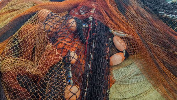 istock Orange and black fishing nets with floats 959075930