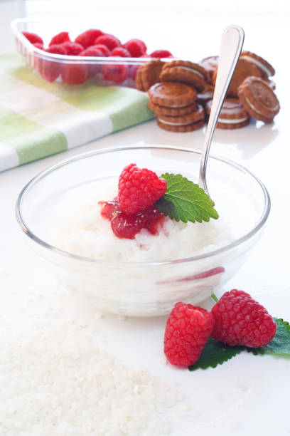 istock Milk Rice porridge with raspberry, white background light key 959081356