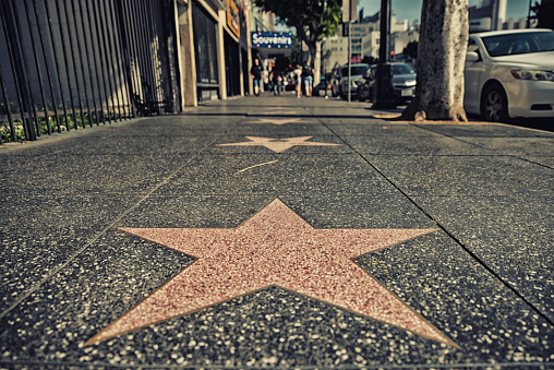 Los Angeles, CA, USA - February 02, 2018:  Walk of Fame at sunset on Hollywood Boulevard. In 1958, the Hollywood Walk of Fame was created as a tribute to artists working in the entertainment industry.