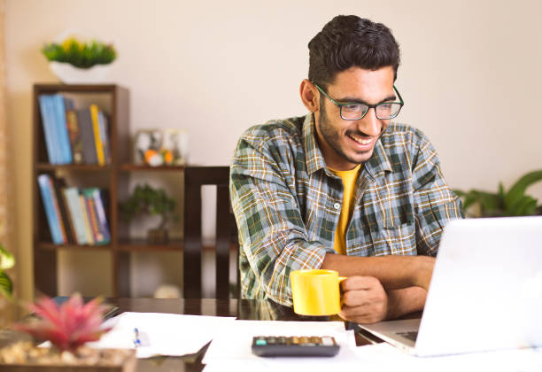 istock Man calculating bills in home office 959093524