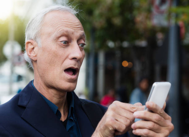 istock Surprised mature businessman looks shocked by text message 959100144