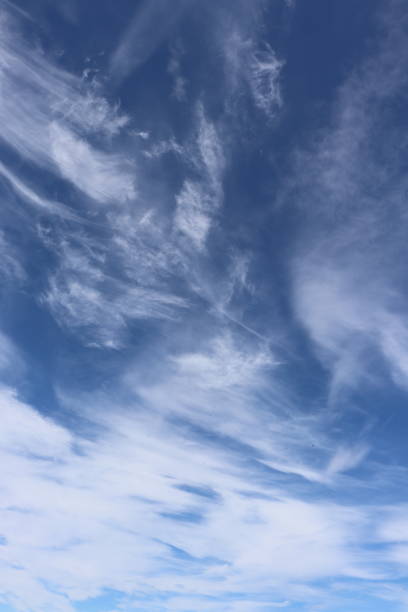 istock Close up of fluffy white clouds in blue sky 959101430