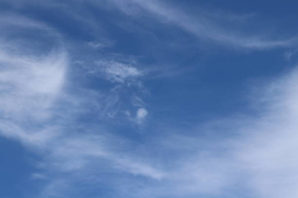 istock Close up of fluffy white clouds in blue sky 959101672