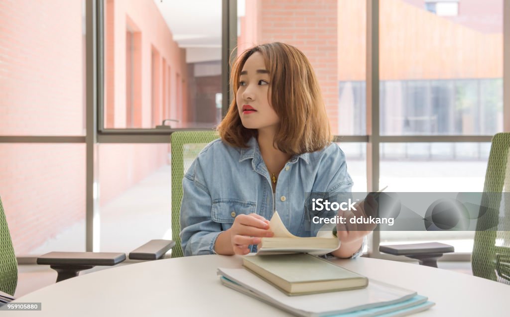 A shot of a beautiful Asian college student with books Asian student Student Stock Photo