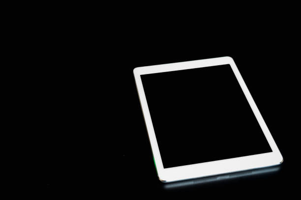 istock White digital tablet on blackwooden table 959109776