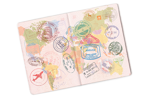 Pasaporte y gran cantidad de sellos en él. Aislado sobre fondo blanco photo