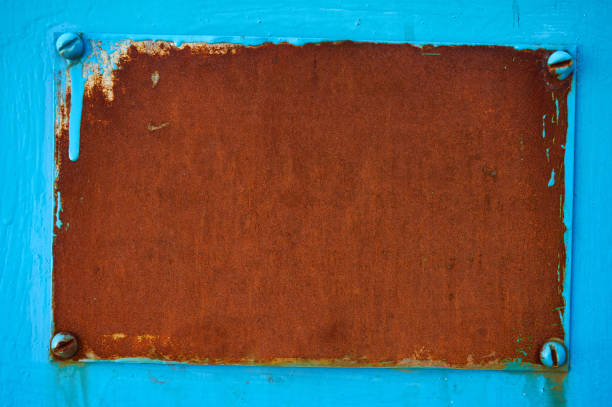 istock Rusty metal plate on a blue background. Abstract background. 959110322
