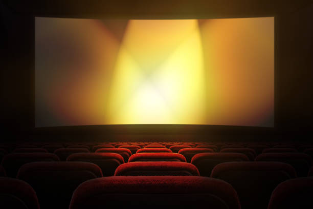 Movie theater with projection screen Movie theater with row of red seats and projection screen with golden lights in the background movie theater photos stock pictures, royalty-free photos & images