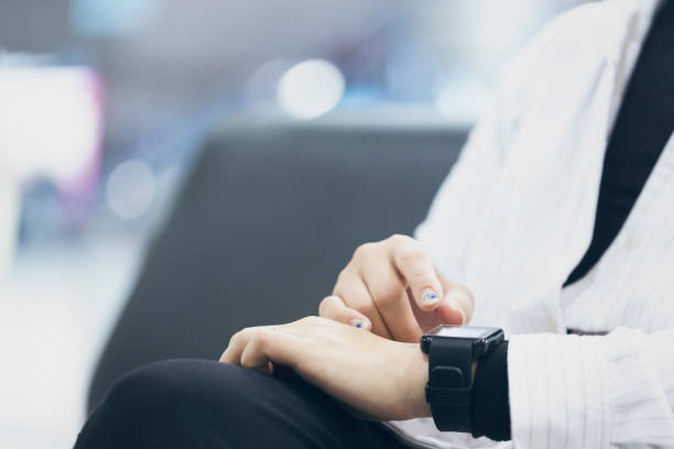istock Woman using a smart watch at the airport 959116090