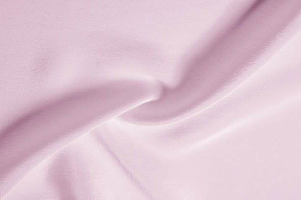 istock Texture background pattern. Pink silk fabric. Closeup of a rippled pink silk fabric. Advertising space. Smooth elegant pink silk can be used as a wedding background. 959118640