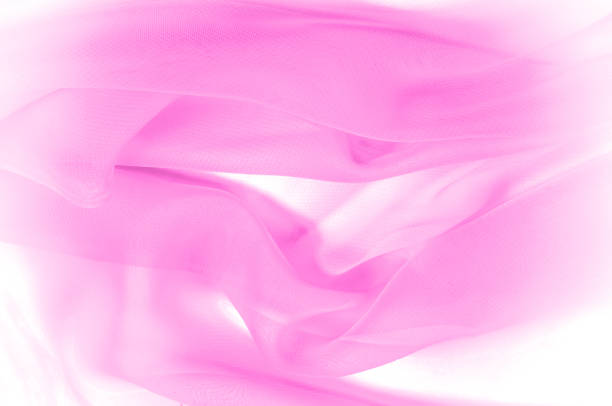 istock texture, pattern. pink silk transparent fabric. Hair is striped silk chiffon. The luxurious silk is woven into a smooth chiffon, to which bands of luminous gold are given in a pale salmon tone. 959119286