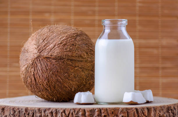 istock coconut milk in glass bottle on natural brown background 959121180