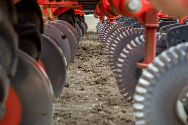 istock discs cutting the cracks in the ground and spreading the seed of a modern seeder 959123782